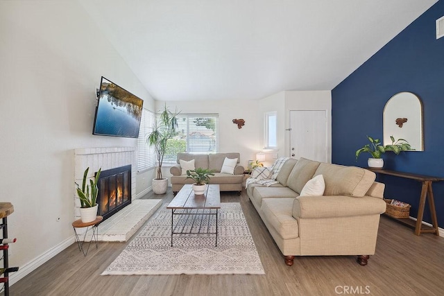 27721 Wakefield Rd, Castaic, CA 91384 - living area with lofted ceiling, wood finished floors, baseboards, and a fireplace