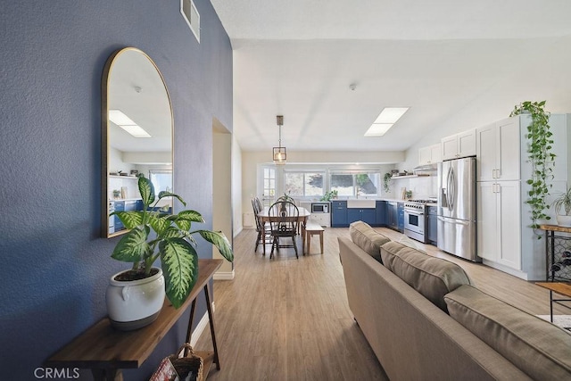 27721 Wakefield Rd, Castaic, CA 91384 - living room with lofted ceiling and light wood-style flooring