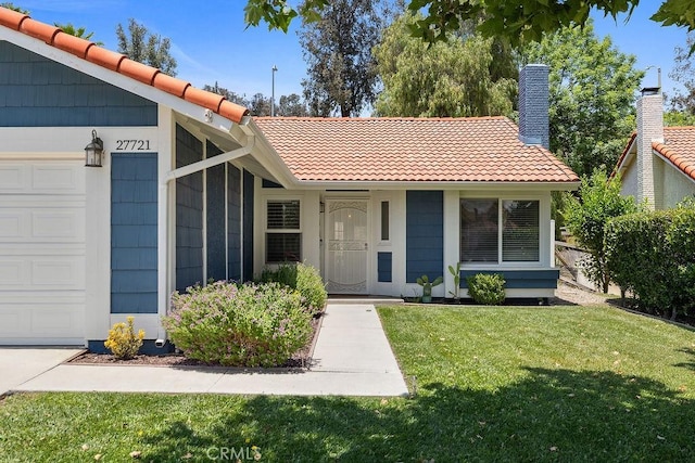 27721 Wakefield Rd, Castaic, CA 91384 - view of front of home with a tile roof, a front lawn, a garage, and a chimney