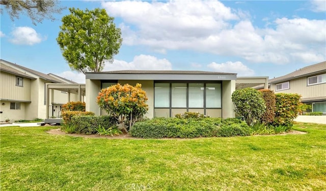 5526 Donner Ave, Buena Park, CA 90621 - rear view of property with a lawn and stucco siding