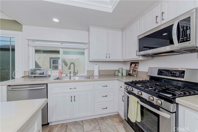 5526 Donner Ave, Buena Park, CA 90621 - kitchen with appliances with stainless steel finishes, a sink, light countertops, white cabinetry, and recessed lighting