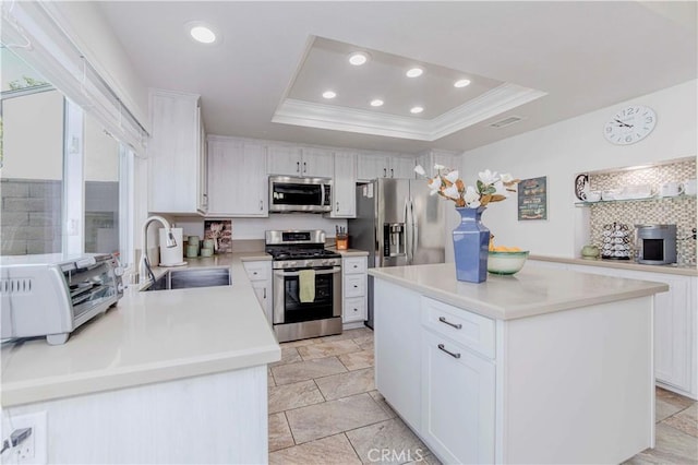 5526 Donner Ave, Buena Park, CA 90621 - kitchen with stainless steel appliances, a sink, a tray ceiling, white cabinetry, and a center island