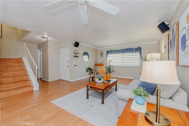 5526 Donner Ave, Buena Park, CA 90621 - living area featuring stairs, wood finished floors, a ceiling fan, baseboards, and crown molding