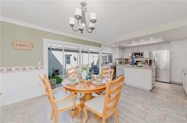 5526 Donner Ave, Buena Park, CA 90621 - dining area with crown molding, a chandelier, a raised ceiling, recessed lighting, and a wainscoted wall