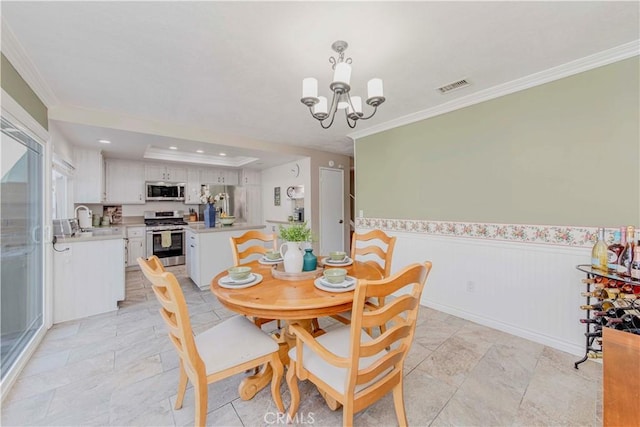 5526 Donner Ave, Buena Park, CA 90621 - dining space with a chandelier, ornamental molding, a wainscoted wall, and recessed lighting