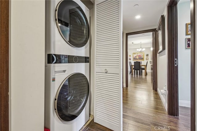 11218 Camarillo St Unit 305, Toluca Lake, CA 91602 - laundry area with stacked washer / dryer, dark wood-type flooring, a chandelier, baseboards, and recessed lighting