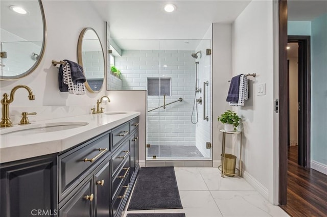 11218 Camarillo St Unit 305, Toluca Lake, CA 91602 - bathroom with double vanity, a shower stall, recessed lighting, baseboards, and marble look tiles