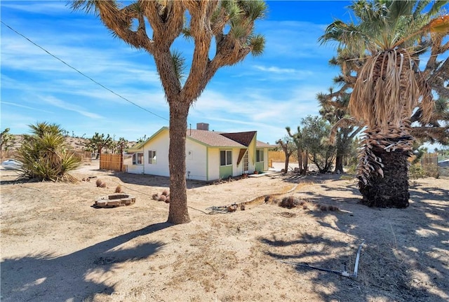 57620 Buena Vista Dr, Yucca Valley, CA 92284 - view of property exterior featuring a fire pit and stucco siding