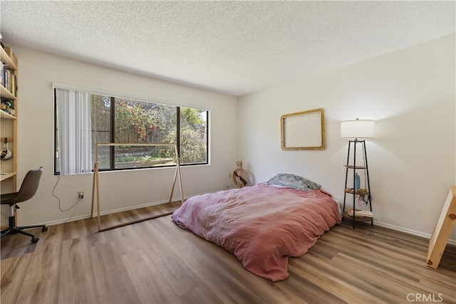 819 Shade Tree Ln, Fallbrook, CA 92028 - bedroom featuring wood finished floors, a textured ceiling, and baseboards