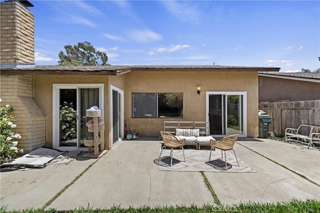 819 Shade Tree Ln, Fallbrook, CA 92028 - back of property with stucco siding, a patio, a chimney, and outdoor lounge area