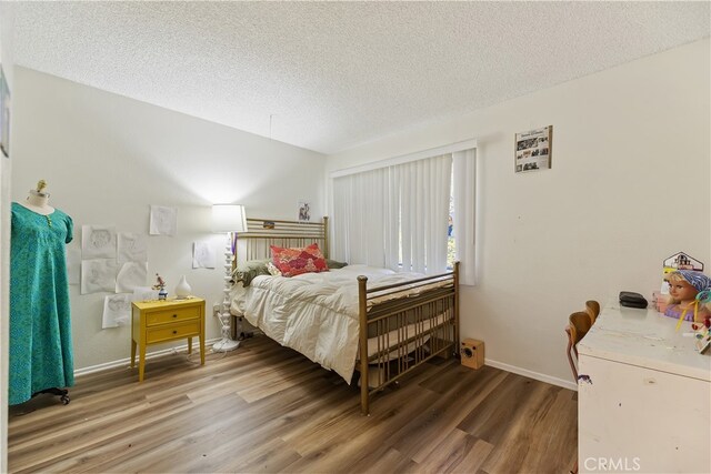 819 Shade Tree Ln, Fallbrook, CA 92028 - bedroom with wood finished floors, a textured ceiling, and baseboards