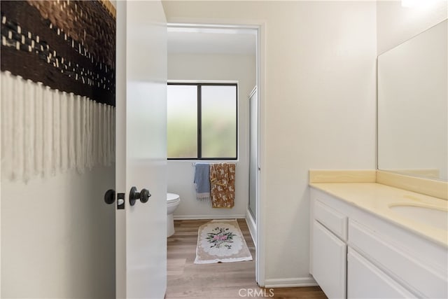 819 Shade Tree Ln, Fallbrook, CA 92028 - full bath with vanity, toilet, wood finished floors, a shower with door, and baseboards