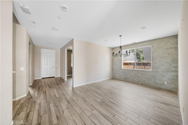 11836 Crossbill Way, Jurupa Valley, CA 91752 - empty room featuring a chandelier, wood finished floors, and baseboards