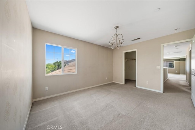 11836 Crossbill Way, Jurupa Valley, CA 91752 - unfurnished bedroom with a chandelier, carpet floors, baseboards, and a spacious closet