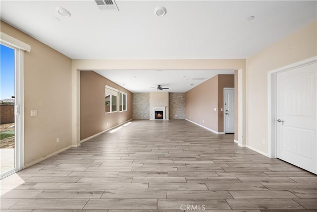 11836 Crossbill Way, Jurupa Valley, CA 91752 - unfurnished living room with plenty of natural light, light wood finished floors, baseboards, and ceiling fan
