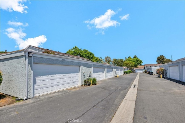 13338 Woodbrook Cir, Garden Grove, CA 92844 - view of asphalt road featuring community garages