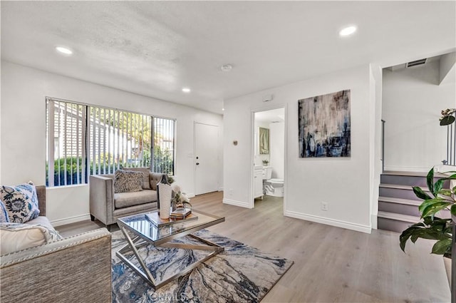 13338 Woodbrook Cir, Garden Grove, CA 92844 - living room featuring light wood-type flooring, baseboards, stairway, and recessed lighting