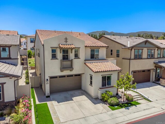 675 Westbrook Loop, San Marcos, CA 92078 - view of front of home featuring a garage, driveway, stucco siding, and a tiled roof