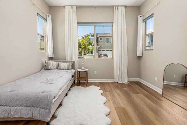 675 Westbrook Loop, San Marcos, CA 92078 - bedroom featuring wood finished floors, multiple windows, and baseboards