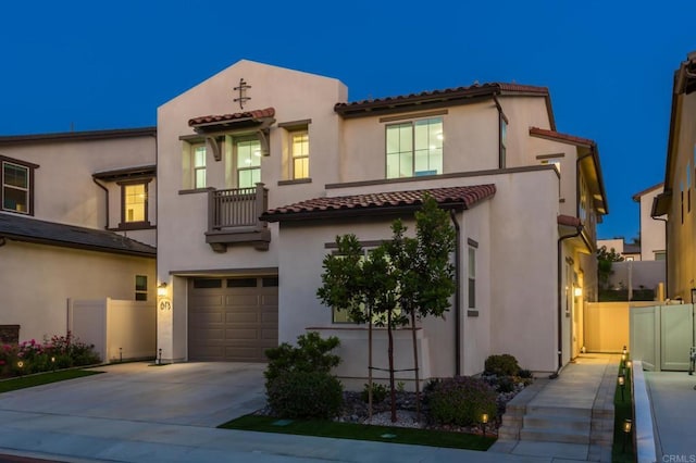 675 Westbrook Loop, San Marcos, CA 92078 - view of front facade with an attached garage, a balcony, concrete driveway, a tiled roof, and stucco siding