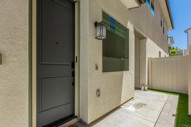 675 Westbrook Loop, San Marcos, CA 92078 - view of exterior entry with stucco siding and a patio area