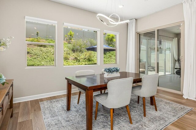 675 Westbrook Loop, San Marcos, CA 92078 - dining space with a chandelier, wood finished floors, and baseboards
