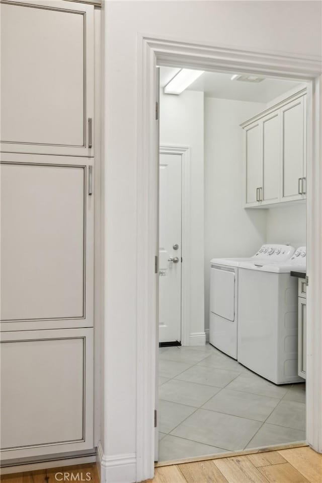 3207 Daisy Ln, San Luis Obispo, CA 93401 - washroom featuring cabinet space, washer and dryer, baseboards, and light tile patterned floors