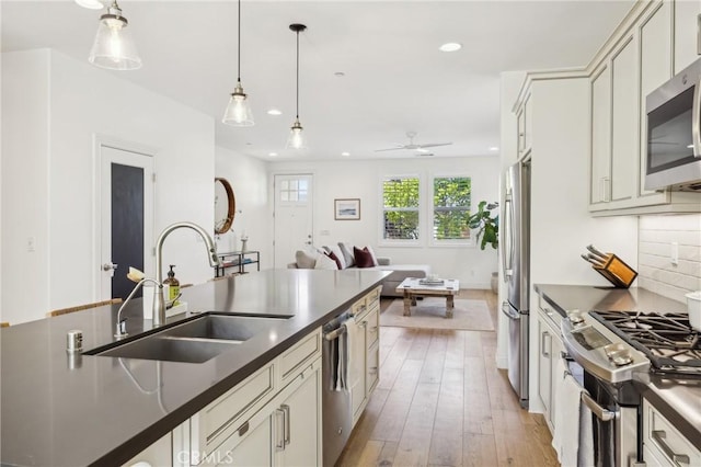 3207 Daisy Ln, San Luis Obispo, CA 93401 - kitchen with appliances with stainless steel finishes, dark countertops, a sink, hanging light fixtures, and recessed lighting
