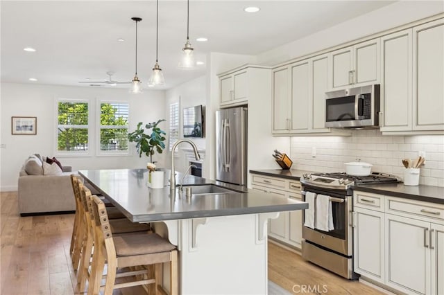3207 Daisy Ln, San Luis Obispo, CA 93401 - kitchen featuring appliances with stainless steel finishes, a sink, dark countertops, healthy amount of natural light, and recessed lighting