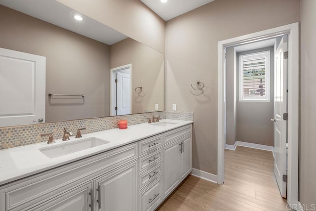 1105 Hibiscus Way, Oceanside, CA 92054 - bathroom with decorative backsplash, double vanity, wood finished floors, baseboards, and recessed lighting