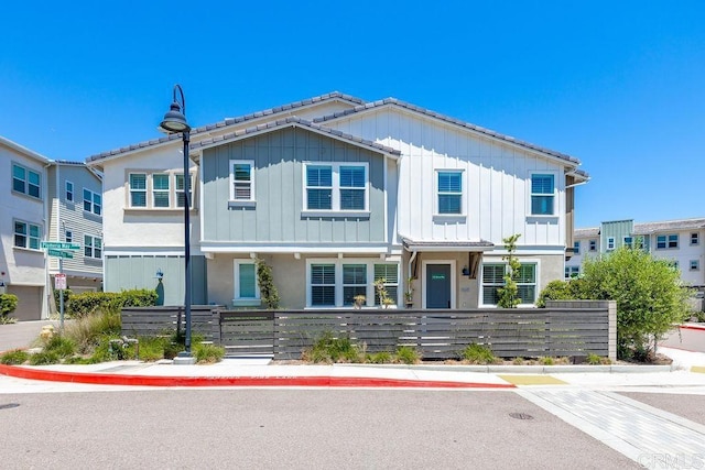 1105 Hibiscus Way, Oceanside, CA 92054 - view of front of house with a fenced front yard, board and batten siding, and stucco siding