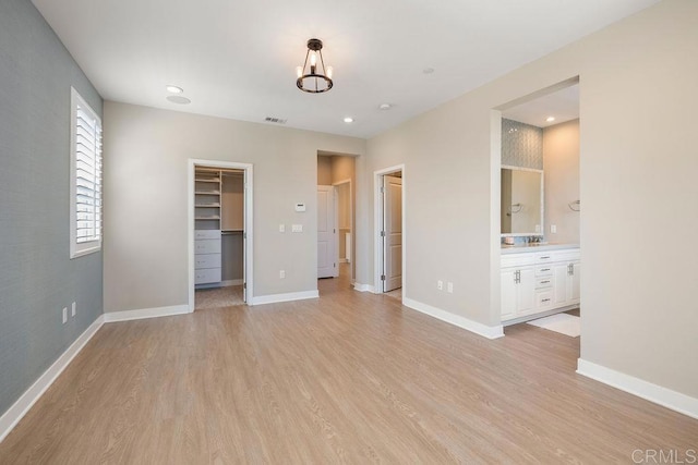 1105 Hibiscus Way, Oceanside, CA 92054 - unfurnished bedroom featuring light wood finished floors, a spacious closet, baseboards, recessed lighting, and a closet