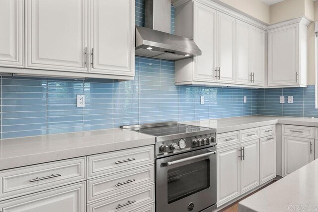 1105 Hibiscus Way, Oceanside, CA 92054 - kitchen with stainless steel range, wall chimney exhaust hood, light countertops, tasteful backsplash, and white cabinets