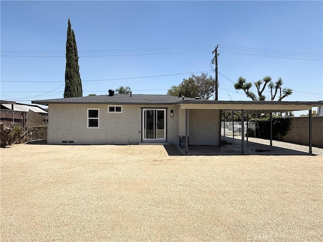 9196 Redwood Ave, Fontana, CA 92335 - rear view of house with stucco siding and an attached carport