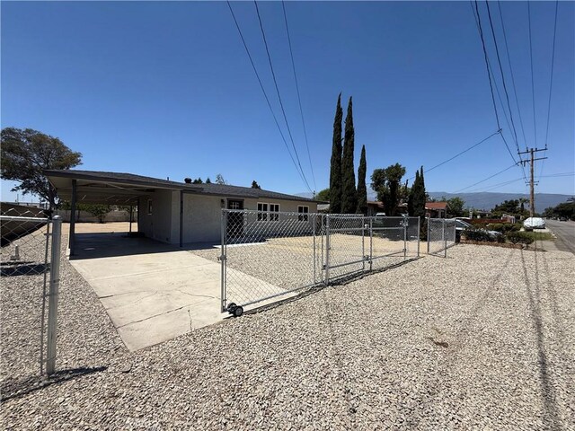 9196 Redwood Ave, Fontana, CA 92335 - view of front facade featuring a gate, driveway, and an attached carport