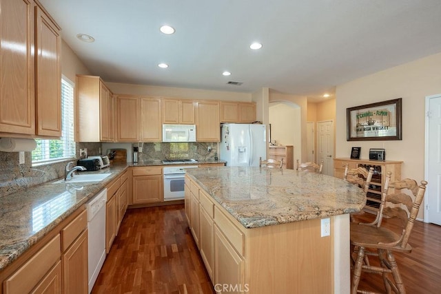 29557 Warmsprings Dr, Menifee, CA 92584 - kitchen featuring white appliances, light brown cabinetry, a sink, dark wood finished floors, and light stone countertops
