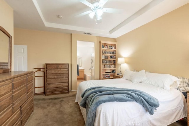 29557 Warmsprings Dr, Menifee, CA 92584 - bedroom with carpet, a tray ceiling, connected bathroom, and a ceiling fan