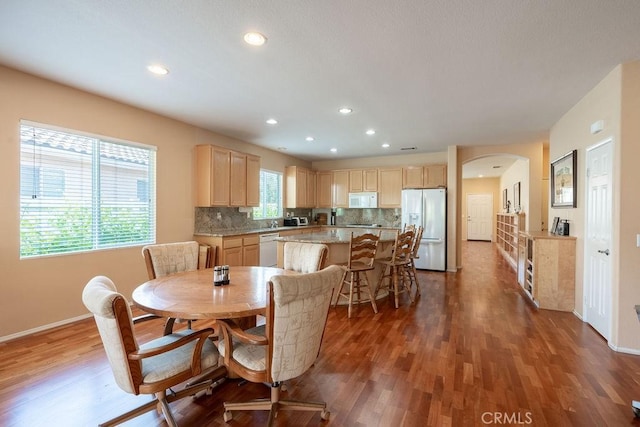 29557 Warmsprings Dr, Menifee, CA 92584 - dining room featuring wood finished floors, arched walkways, baseboards, and recessed lighting