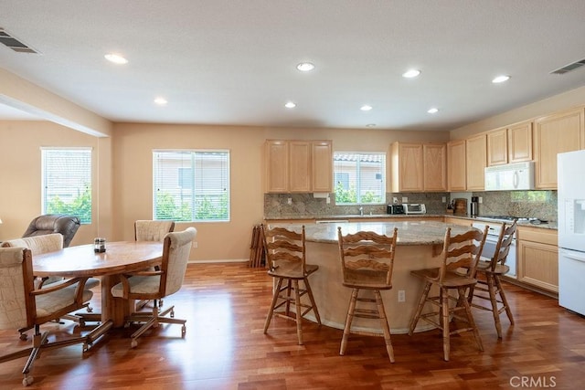 29557 Warmsprings Dr, Menifee, CA 92584 - kitchen with white appliances, light brown cabinets, recessed lighting, wood finished floors, and backsplash