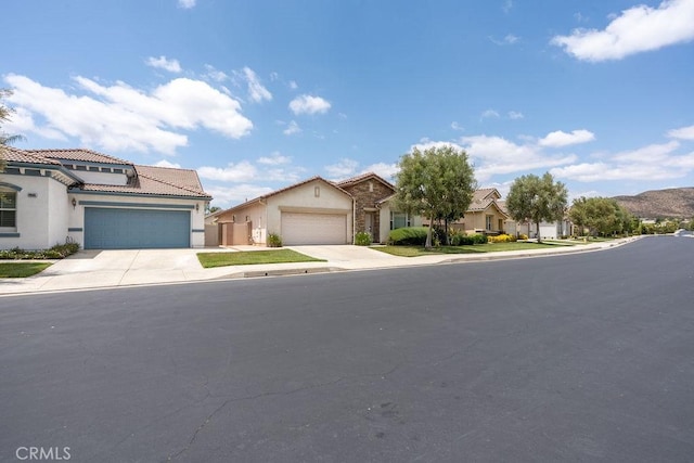 29557 Warmsprings Dr, Menifee, CA 92584 - view of front of property with stucco siding, an attached garage, driveway, and a tile roof