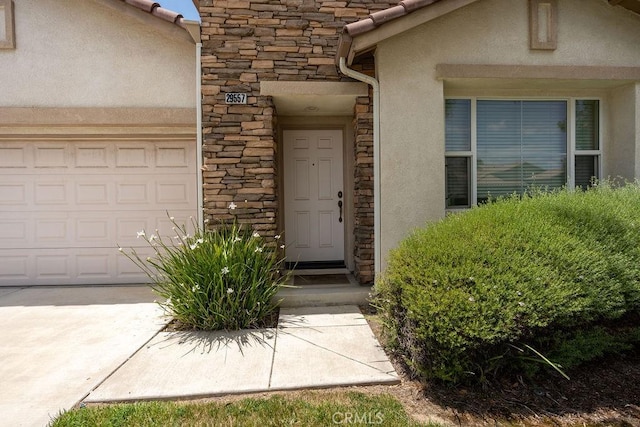 29557 Warmsprings Dr, Menifee, CA 92584 - property entrance featuring stone siding, stucco siding, and an attached garage
