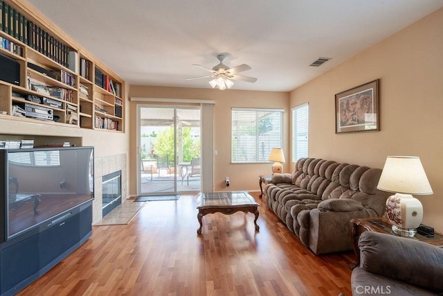 29557 Warmsprings Dr, Menifee, CA 92584 - living area with ceiling fan, wood finished floors, and a tile fireplace