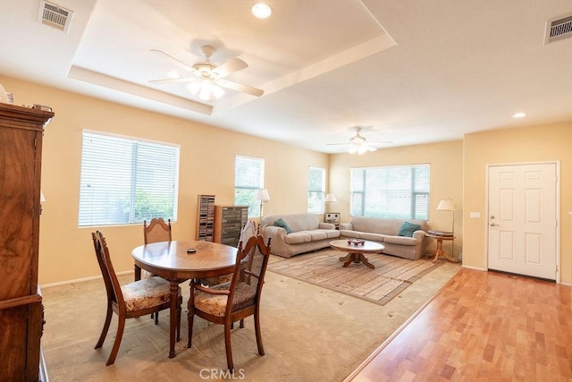 29557 Warmsprings Dr, Menifee, CA 92584 - dining area with a ceiling fan, baseboards, light wood-style floors, a raised ceiling, and recessed lighting