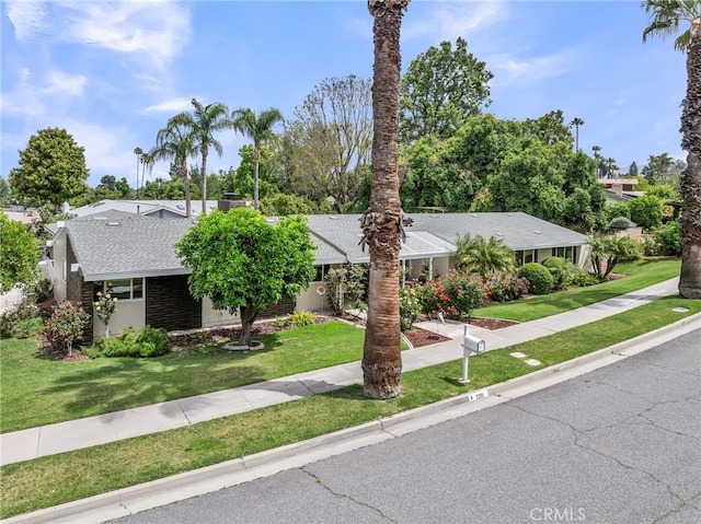 2201 Archdale St, Riverside, CA 92506 - view of front of home featuring a shingled roof, a front lawn, a chimney, and brick siding