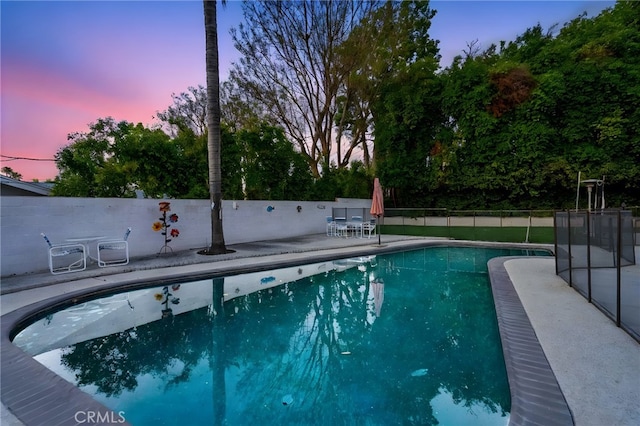 2201 Archdale St, Riverside, CA 92506 - pool at dusk featuring a patio area