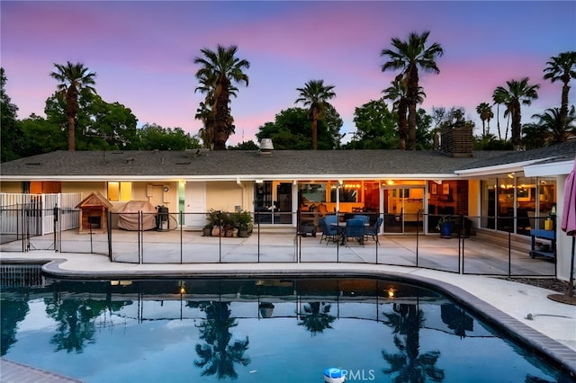 2201 Archdale St, Riverside, CA 92506 - rear view of property with a patio, an outdoor pool, and a chimney