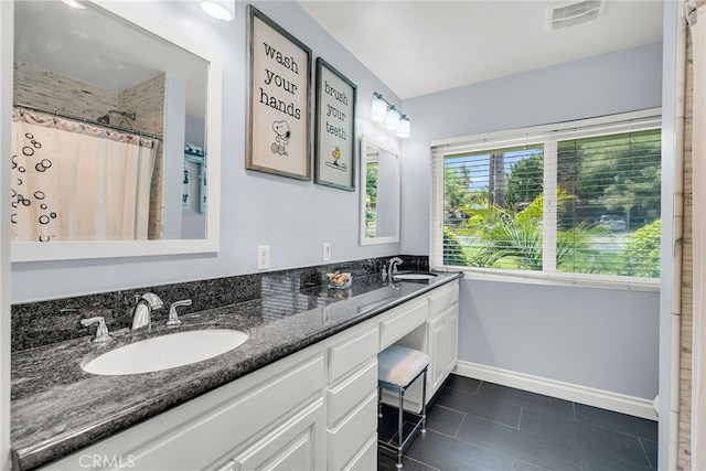 2201 Archdale St, Riverside, CA 92506 - full bath featuring tile patterned floors, double vanity, and baseboards