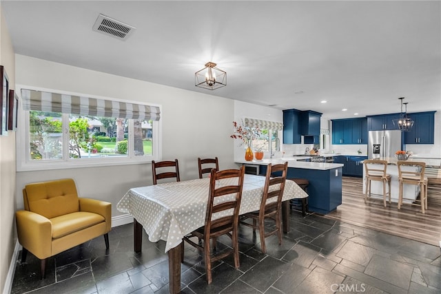 2201 Archdale St, Riverside, CA 92506 - dining room with a chandelier, baseboards, recessed lighting, and stone tile flooring