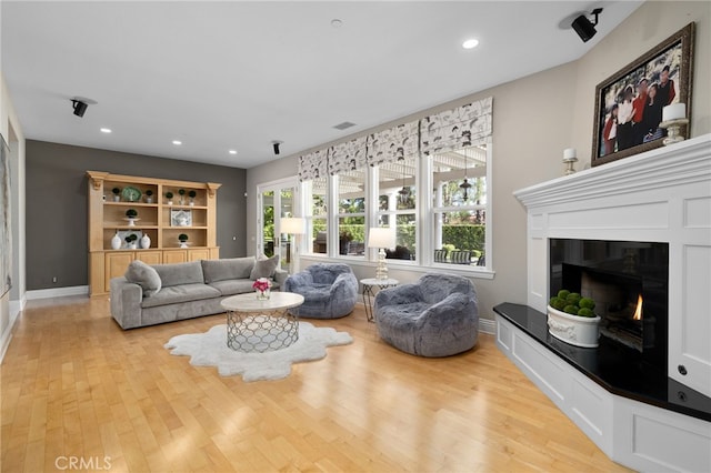 4160 New Hampshire Ave, Claremont, CA 91711 - living area with light wood-style floors, baseboards, recessed lighting, and a glass covered fireplace