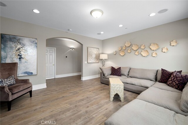 4160 New Hampshire Ave, Claremont, CA 91711 - living room featuring arched walkways, wood finished floors, baseboards, and recessed lighting